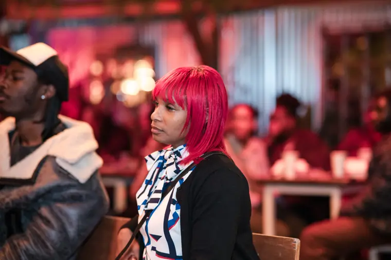 A guest listens to a speaker.
