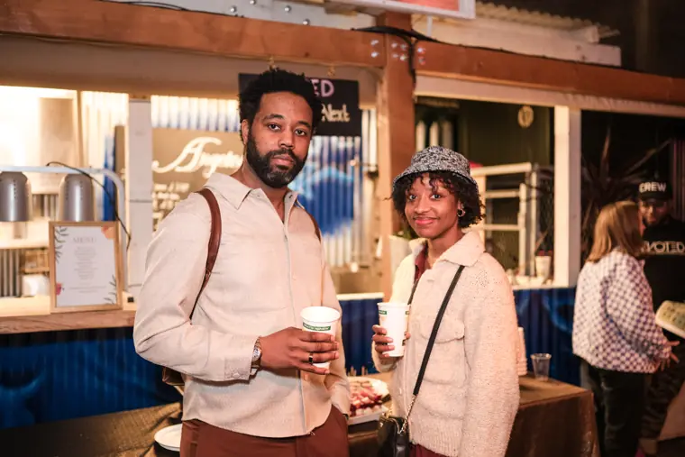 Two guests pose by the bar.