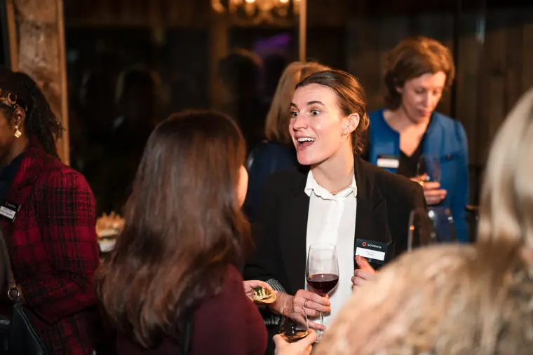 A guest smiles during a conversation at the event.