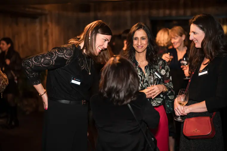 Guests gather for a conversation near the bar.