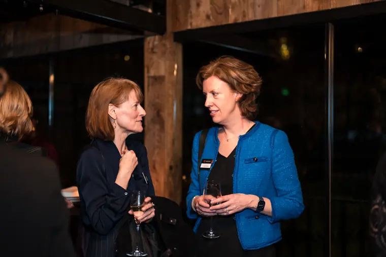 Two guests share a focused conversation.