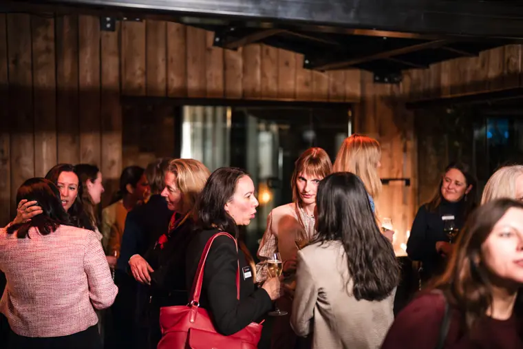 The networking room fills with attendees.