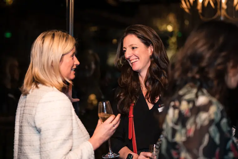 Two women catch up during the reception.