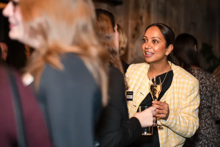 A guest speaks with colleagues at the reception.