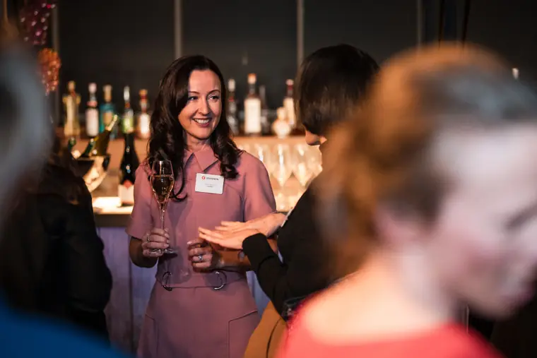 An attendee smiles from across the reception.