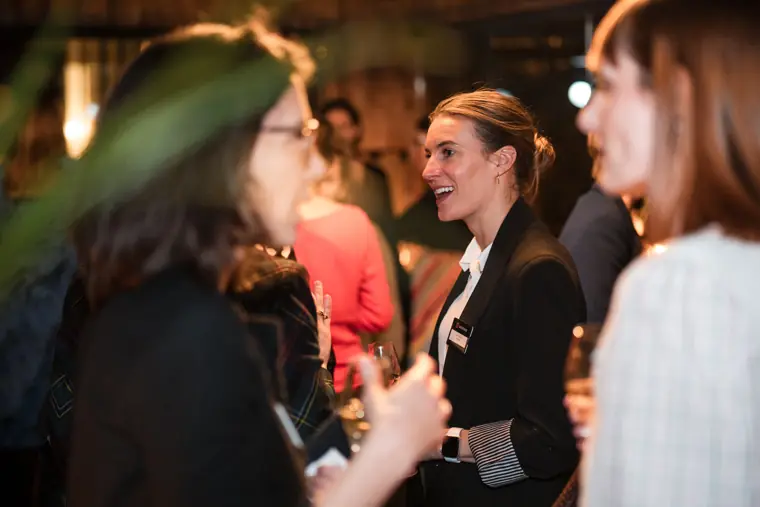 Three women share a conversation together.