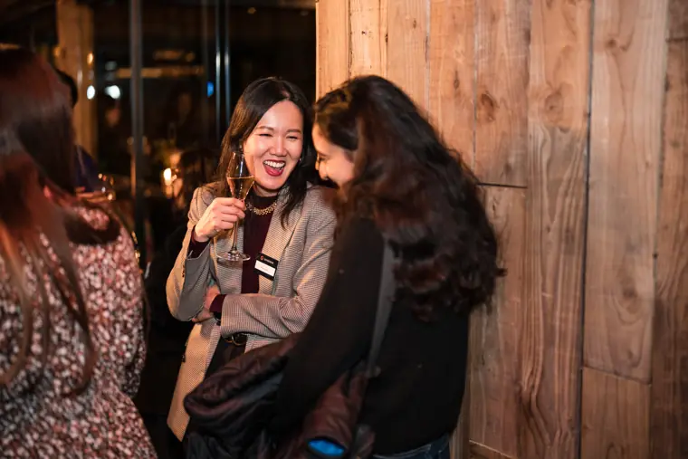Two attendees enjoy a lighter moment.