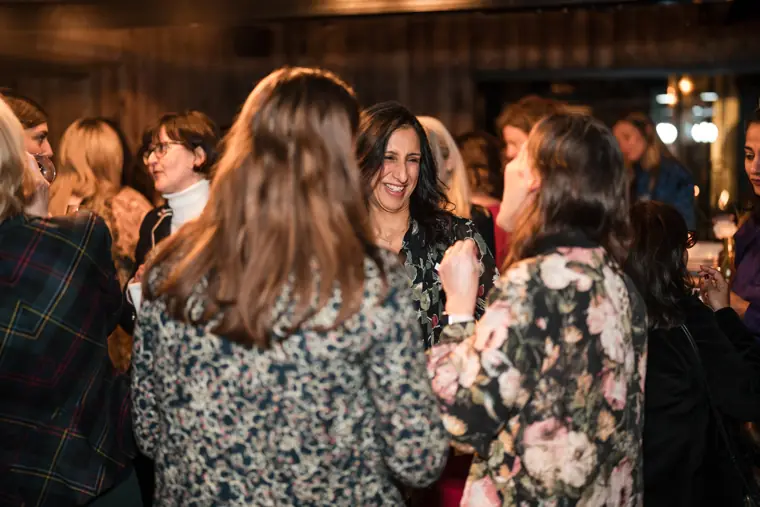 Guests meet in the crowded networking room.