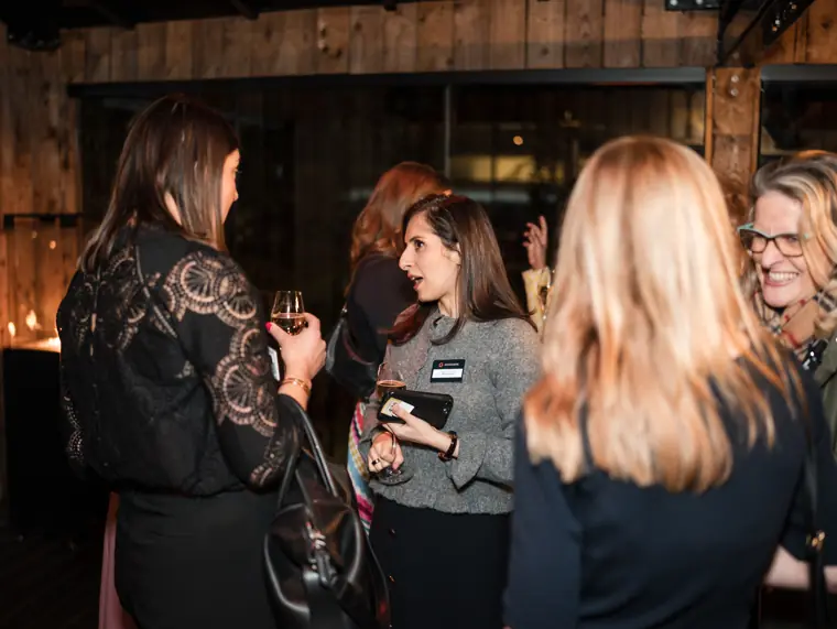 Guests meet around the drinks table.