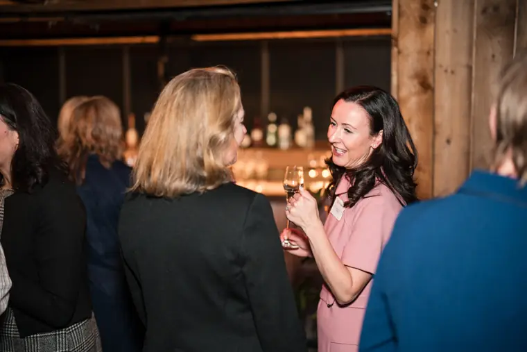 A group shares a conversation near the bar.