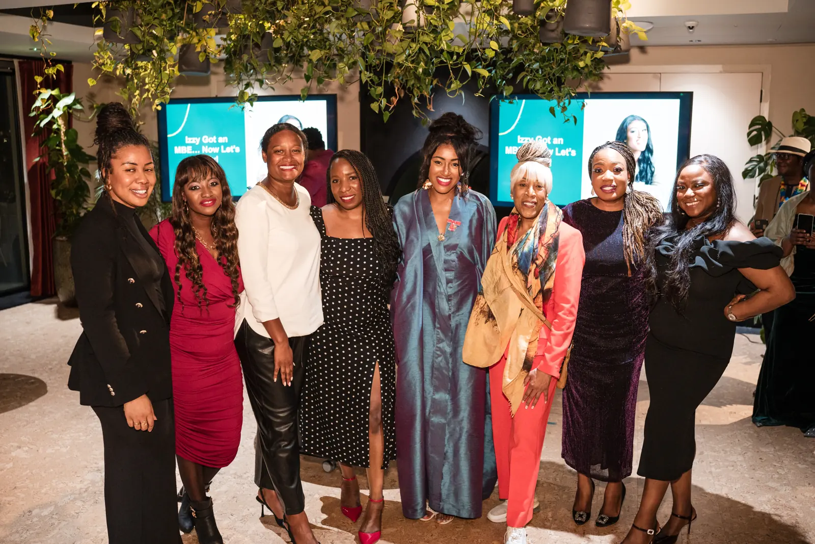 Izzy Obeng celebrating her MBE with guests.
