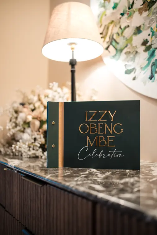 Izzy Obeng MBE celebration sign.
