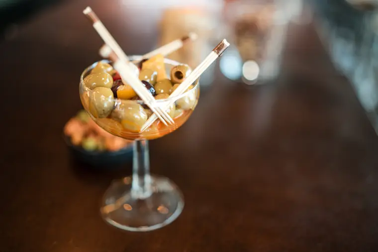 Close-up of a cocktail garnished with fruit.