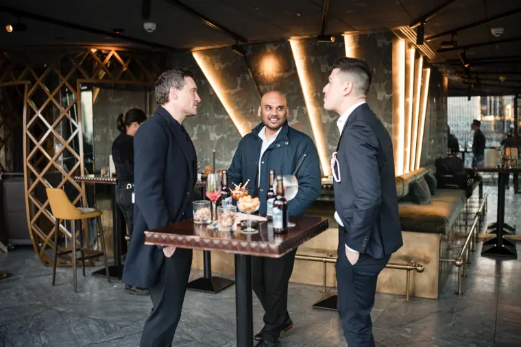 Colleagues greeting one another inside the venue.