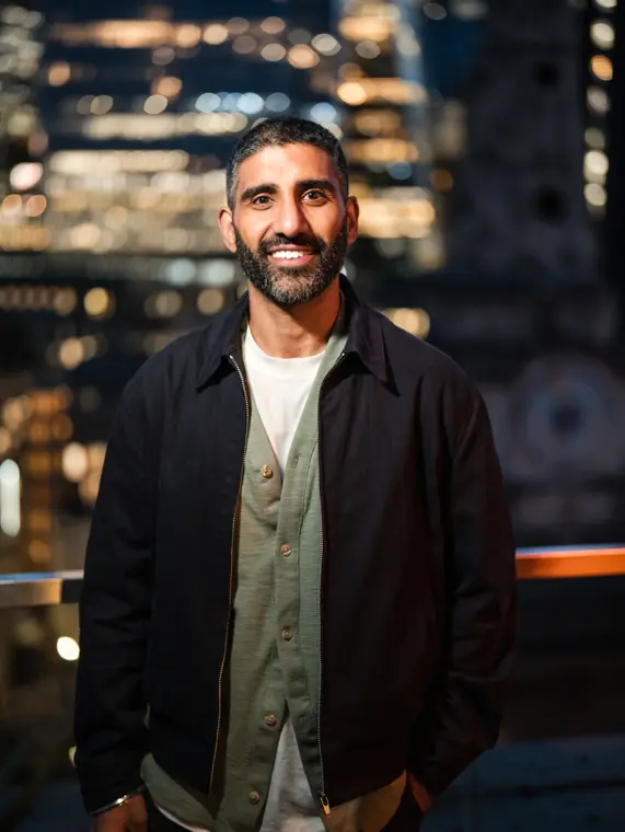 Portrait of a smiling guest in a dark jacket.