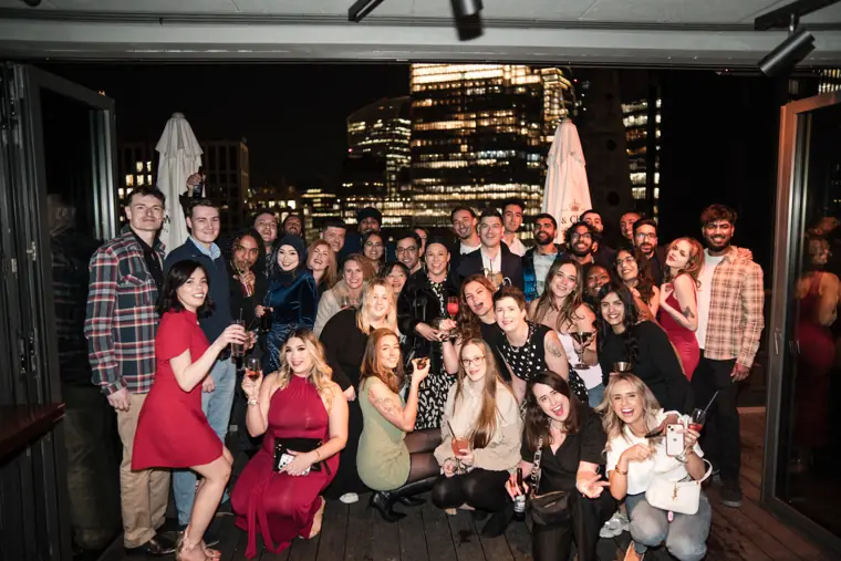 Wide group portrait of the MaMedica team on the rooftop.