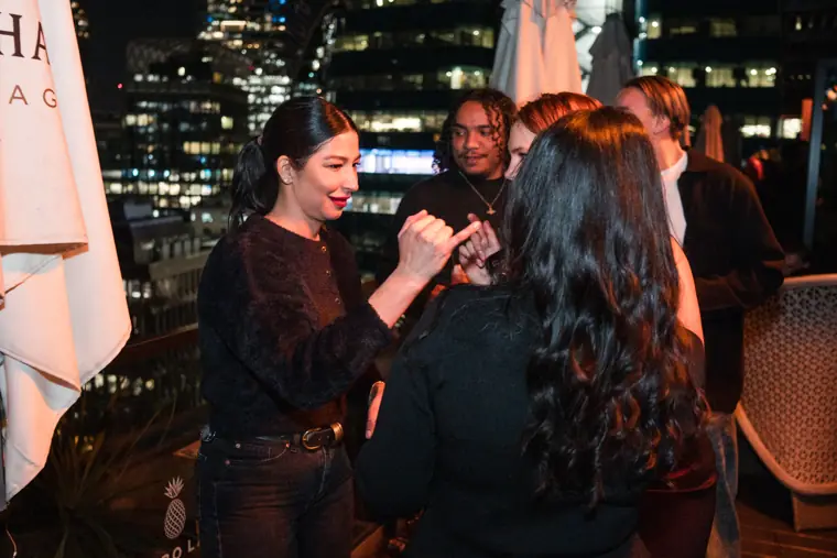 Women catching up over drinks at the reception.