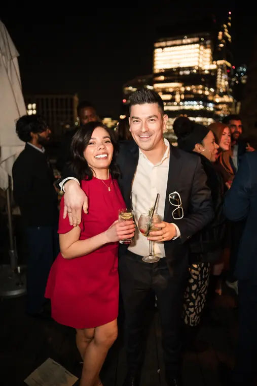 A woman in red posing with another guest.
