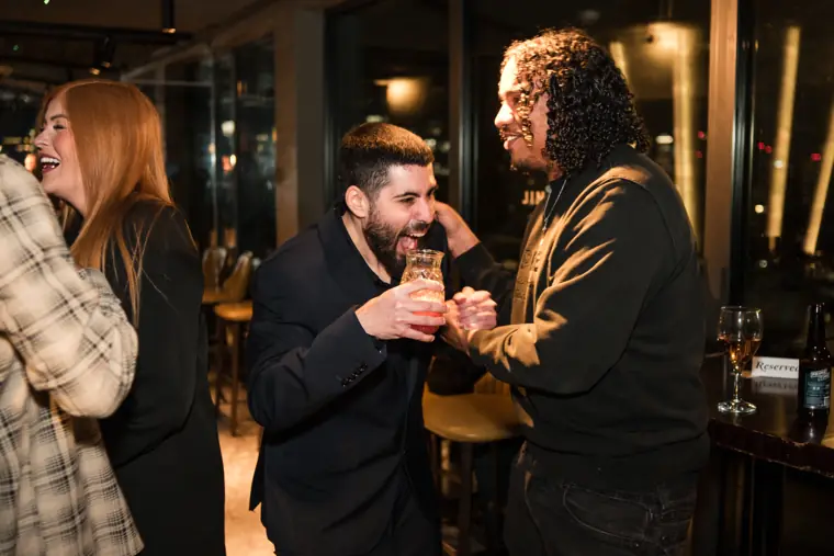 Guests applauding and sharing a light moment.