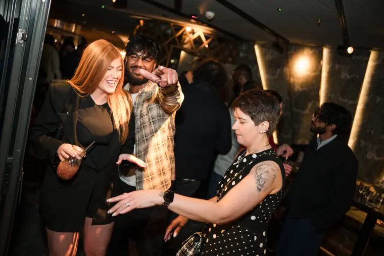 Guests dancing and laughing together at the celebration.
