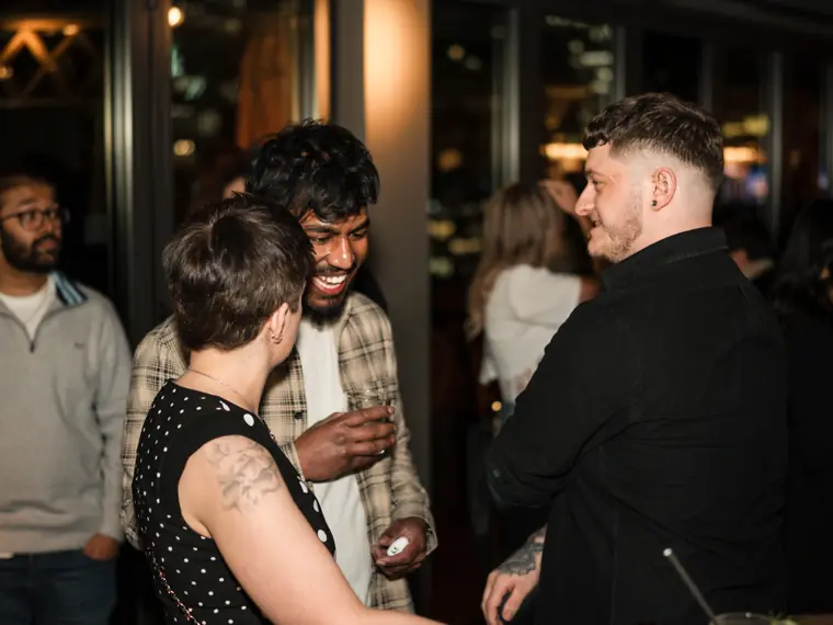 Colleagues talking together near the bar.