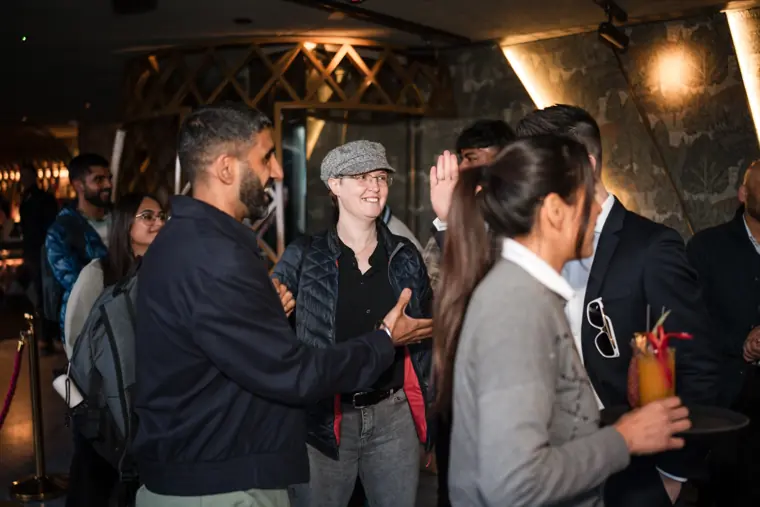Two colleagues greeting each other inside the venue.