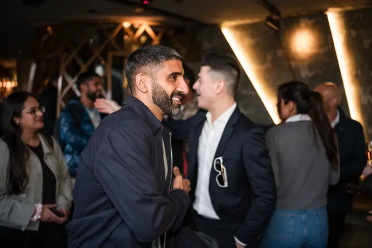 Two men sharing a conversation near the bar.