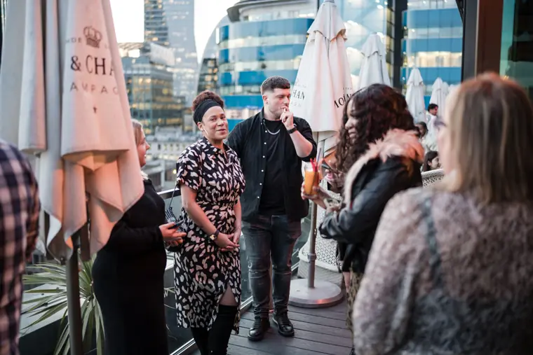 Guests mingling on the terrace in the early evening.
