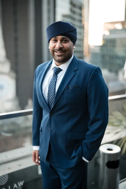 Portrait of a team member in a blue suit and turban.