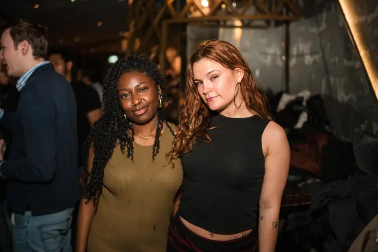 Two women chatting together inside the venue.