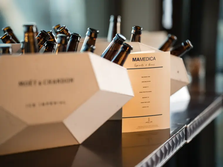 Drinks displayed beside a MaMedica event card.