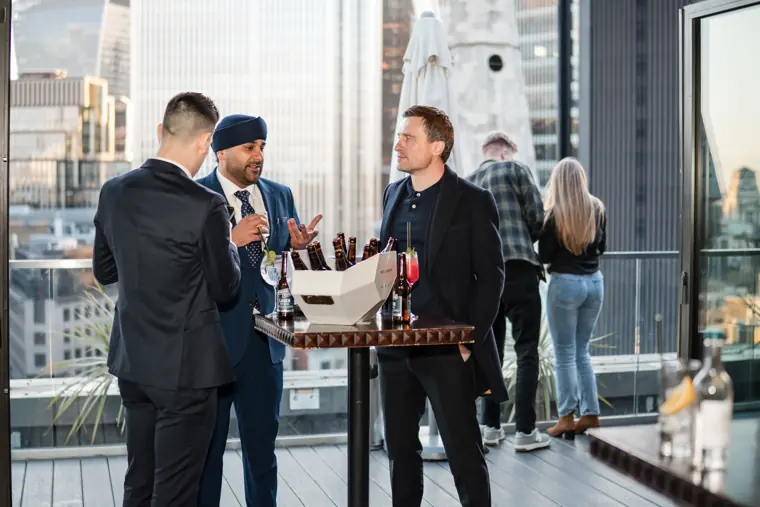 A guest in a blue suit at the drinks station.