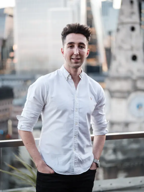 Portrait of a guest in a white shirt outside.