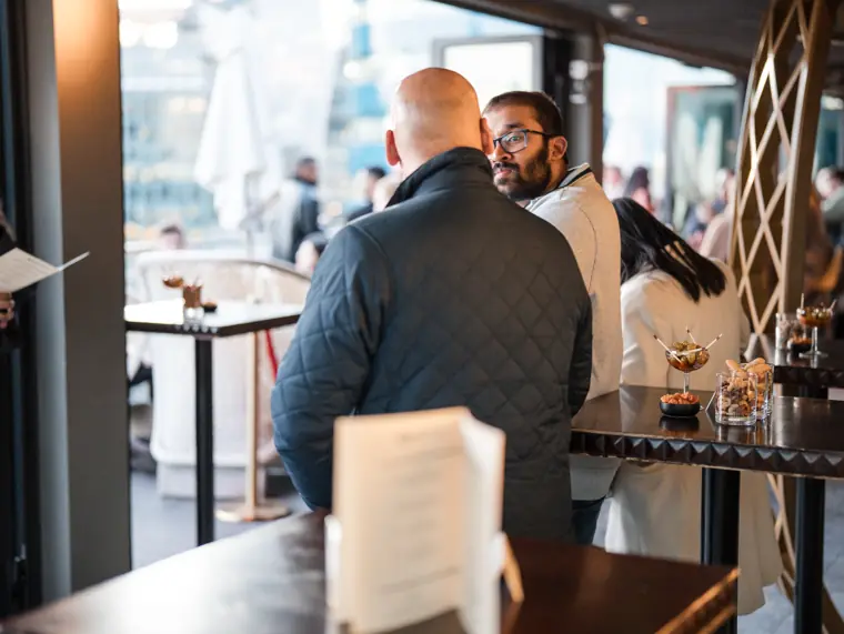 Guests meeting in the daylight reception area.