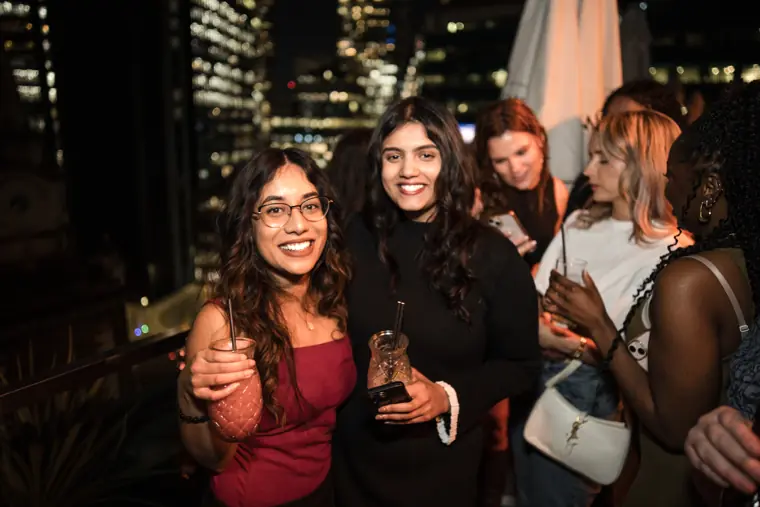 Guests smiling together in a close group photograph.