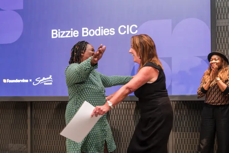 Founder receiving recognition at the showcase.