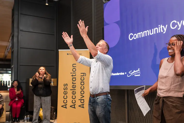 Founder receiving recognition at the showcase.