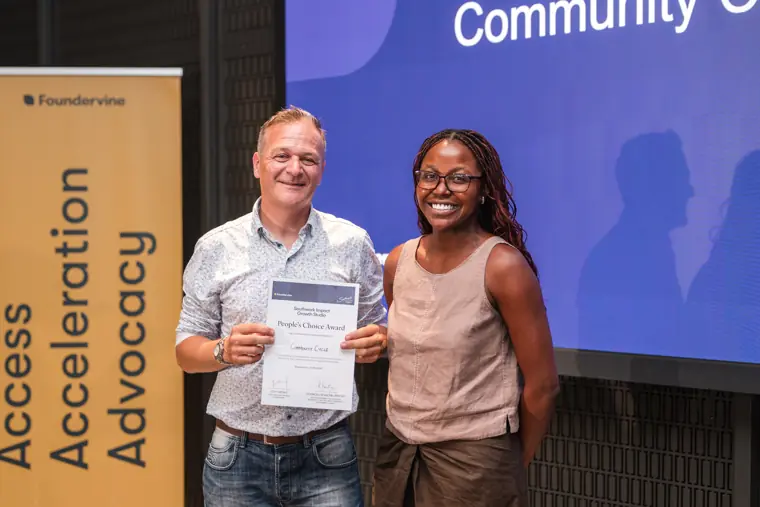 Founder receiving recognition at the showcase.