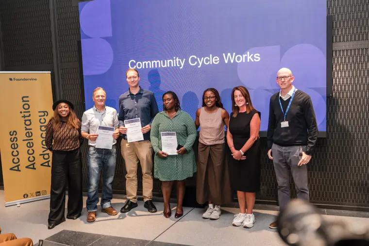 Founder receiving recognition at the showcase.