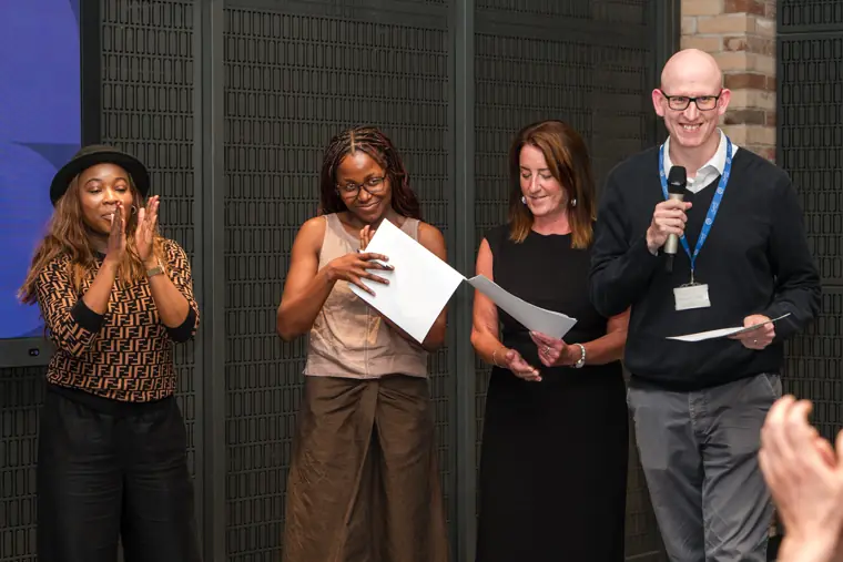 Founder receiving recognition at the showcase.