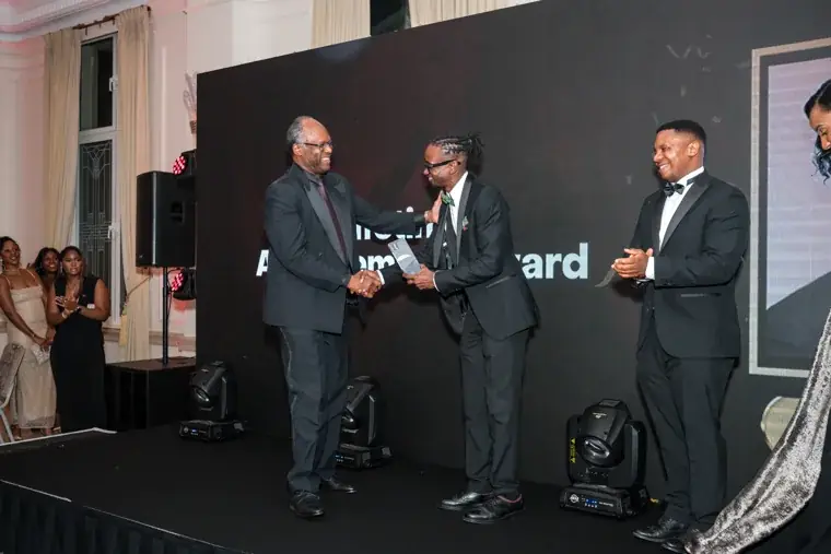 Award recipient shaking hands during the presentation at the Black Pharma fifth anniversary gala.
