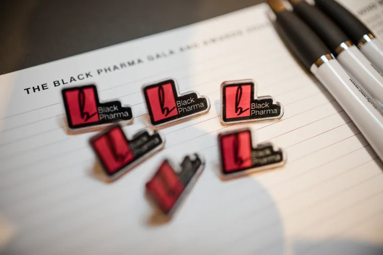 Black Pharma anniversary badges arranged for attendees at the Black Pharma fifth anniversary gala.