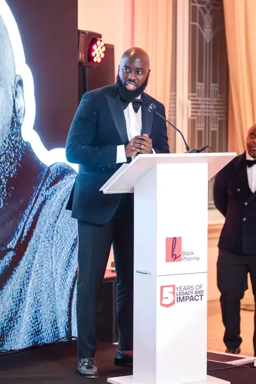 Black Pharma gala speaker at the branded lectern at the Black Pharma fifth anniversary gala.