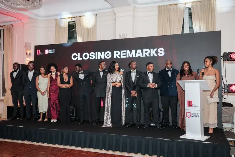 Black Pharma team standing together for closing remarks at the Black Pharma fifth anniversary gala.
