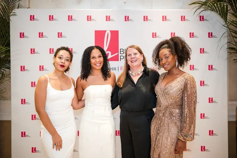 Four guests posing together before dinner at the Black Pharma fifth anniversary gala.