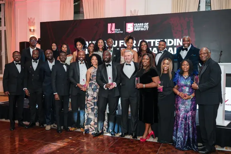 Gala team posing together beneath the thank-you screen at the Black Pharma fifth anniversary gala.