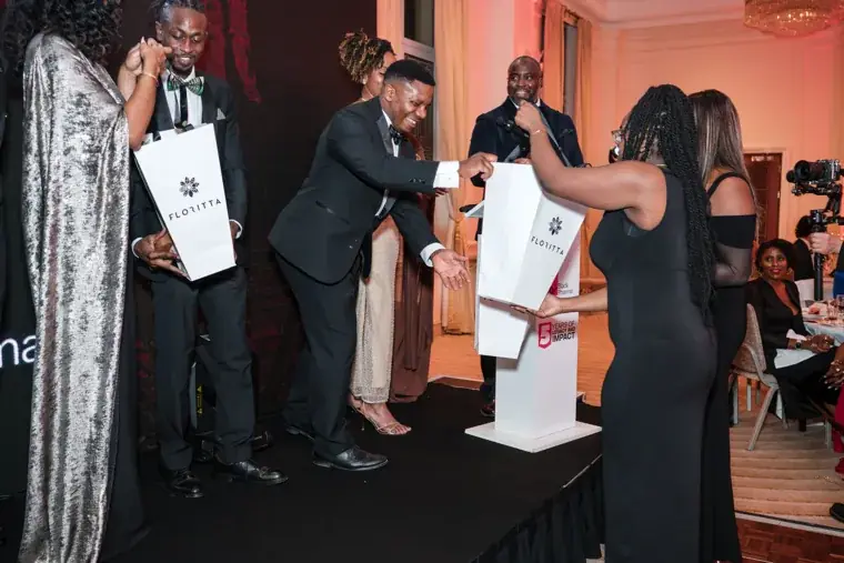 Gift being presented to a speaker on the gala stage at the Black Pharma fifth anniversary gala.