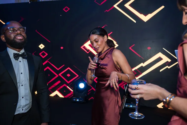 Guest dancing beneath coloured lights after the awards at the Black Pharma fifth anniversary gala.