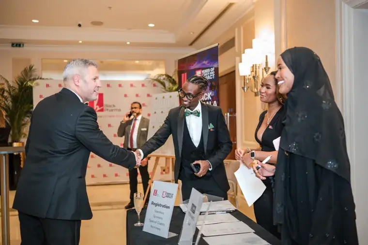 Guests exchanging greetings beside the reception area at the Black Pharma fifth anniversary gala.