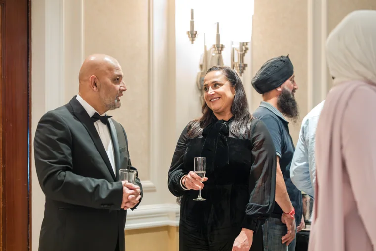 Guests sharing a conversation over drinks at the Black Pharma fifth anniversary gala.